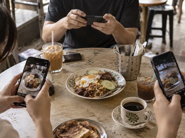 Several diners photographing the same dish at a casual restaurant table, illustrating how shared attention can form around food.